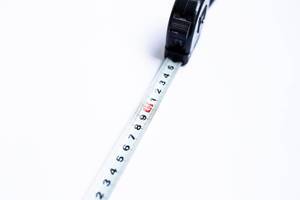 Close up of tape measure numbers on white background