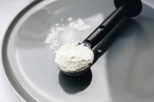 Close up of vanilla protein powder in a spoon.