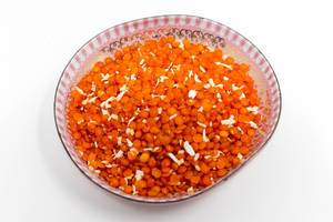 Close-up of whole red lentils and grated coconut in an Indian spice mixture by Davert