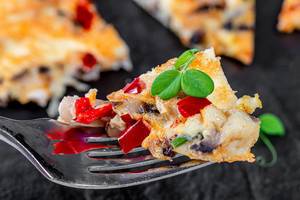 Close-up omelette with vegetables on a fork (Flip 2019)