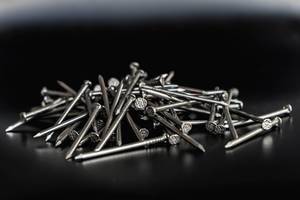 Close up on a Pile of Nails on the Black Background