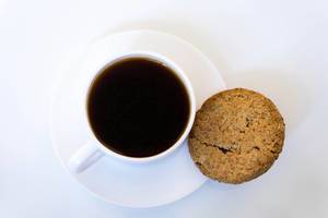 Close Up on coffee with cookies on white background