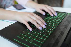 Close Up on female hands typing on a laptop