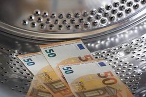 Close Up Photo of 50 Euro Banknotes in a Washing Machine Drum to depict Money Laundering