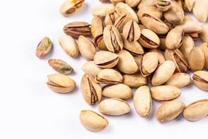 Close Up Photo of Bunch of Pistachios on White Background
