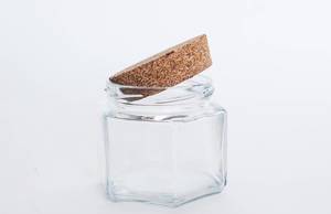 Close Up Photo of Empty Glass with Cork Lid on white Background