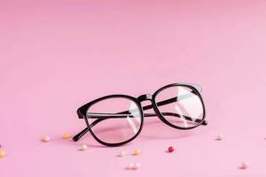 Close Up Photo of Glasses with Small Colorful Pearls on pink Background