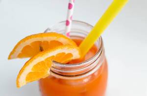 Close Up Photo of Healthy Vitamin Drink with Fresh Orange Slices and Paper Straw