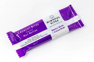 Close Up Photo of Mindful Bites Vegan Snack Bar Crunchy Bites filled with Nut Butter Brazil Nuts and Cacao Nibs on White Background