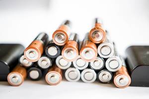 Close Up Photo of Stack of Batteries on White Background