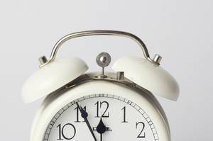 Close Up Photo of White Vintage Timer Clock on White Background