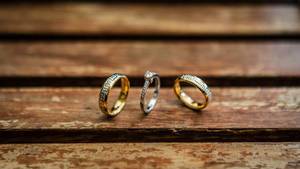 Close up shot of wedding rings on a wooden table  Flip 2019
