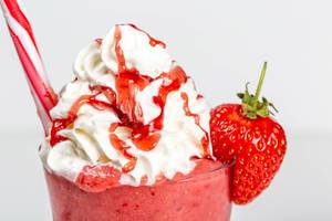 Close-up, strawberry cocktail with whipped cream and a straw