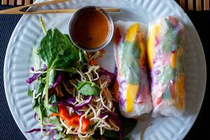 Close Up Top View Food Photo of Fresh Vegetarian Summer Rolls with Vermicelli Salad and Sauce on a White Plate