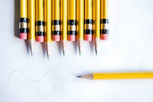 Close Up Top View Photo of Yellow Pencils with Eraser on White Paper Background