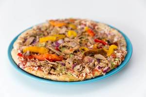 Close up Vegetarische Protein Pizza mit Leinsamen, Quinoa und pulled Soybeans von Garden Gourmet ausgepackt gefroren auf einem Teller