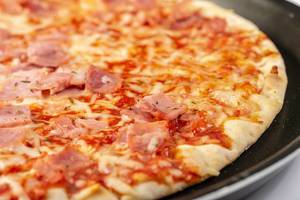 Closeup of Baked Pizza with Ham (Flip 2019)