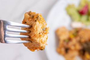 Closeup of Chicken Meat on the fork with blurred background