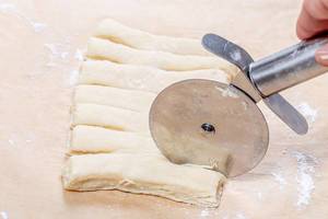 Closeup of cutting the dough for the buns (Flip 2019)