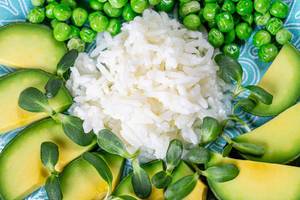 Closeup white rice with avocado, green peas and sunflower microgreen (Flip 2020)