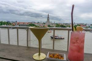Cocktails and Peanuts with a View of Wat Arun Temple in Bangkok