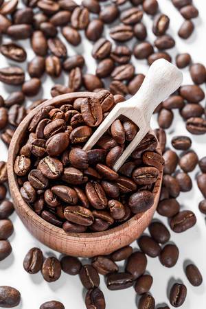 Coffee beans in a wooden bowl background