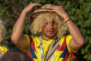Colombian soccer fan with blonde wig and straw hat