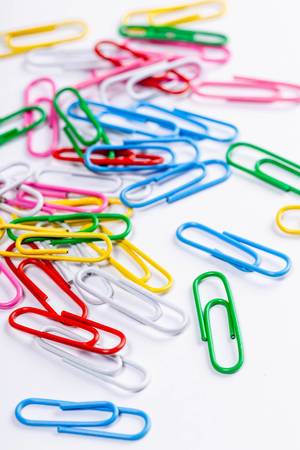 Colored paper clips on white background (Flip 2019)