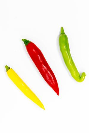 Colorful chilis on white background