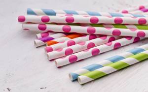 Colorful Doted and Striped Paper Straws on a White Table