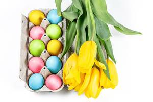 Colorful Easter eggs with a bouquet of tulips