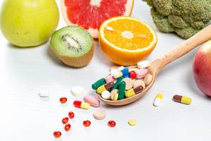 Colorful fruits and pills.The concept of vitamins in food and medicines