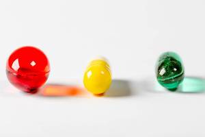 Colorful medical capsules on white background