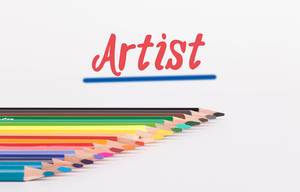 Colorful pencils on white background with text Artist