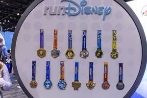 Colorful RunDisney medals with comic characters for participants of half marathon, kids races and dopey challenge