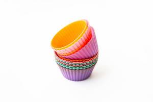 Colorful silicone muffin cups on white background  Flip 2019