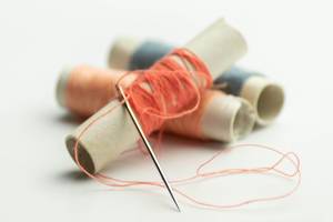 Colorful threads on spools with a needle