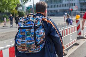 Colorful travel rucksack with photos of different travel destinations