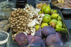 Colourful ingredients for a healthy lunch: Mushrooms, figs and green fruits in a box