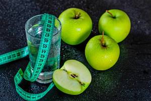 Components of food during the diet-apples and water with measuring tape