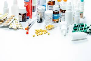Composition of medicine bottles and pills on white background (Flip 2019)