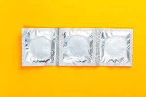 Condoms on a yellow background. Top view