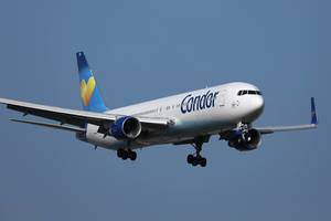 Condor plane approaching to landing, blue sky