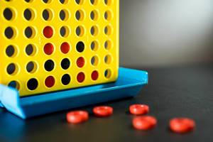 Connect four game over a black surface