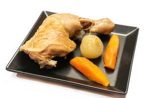 Cooked chicken drumstick with vegetables on the plate