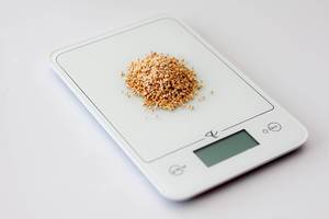 Cooking Scale Tool on a White Background With Quinoa on Top