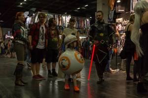 Cosplayer family clad as Jedi, Sith and BB-8 robot