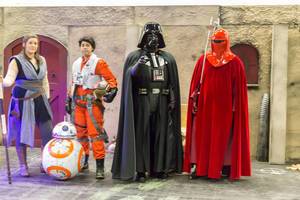 Cosplayers dressed as Darth Vader and other Star Wars characters