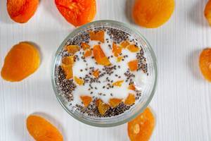 Cottage cheese with yogurt, Chia seeds and pieces of dried apricots. Top view