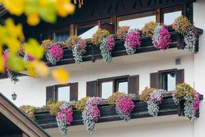Countryside house in German village Reit im Winkl, flowers at balconies